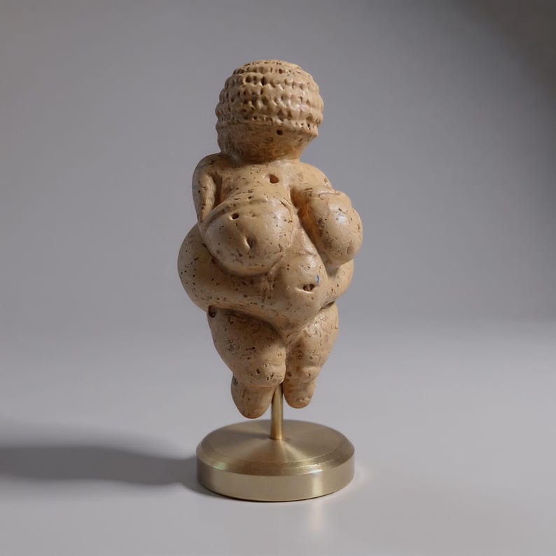 Venus of Willendorf replica on bookshelf home décor, small statue