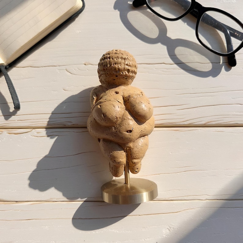 Venus of Willendorf statue held in hand