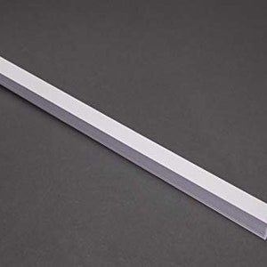 May include: A white plastic strip, approximately 12 inches long, with a rectangular cross-section.