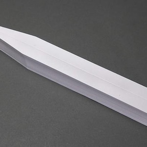 May include: White plastic plant label with a pointed end. The label is blank and ready to be written on.