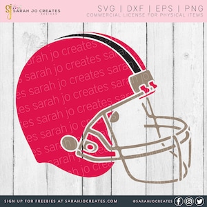 May include: A red and brown football helmet with a face mask. The helmet is on a white wood background.