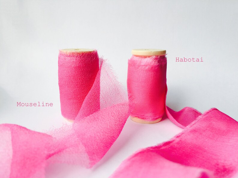May include: Two spools of pink ribbon, one labeled "Habotai" and the other labeled "Mouseline".