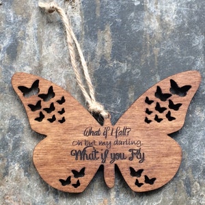May include: Wooden butterfly ornament with a cutout design and the text "What if I fall? Oh but my darling, What if you fly."