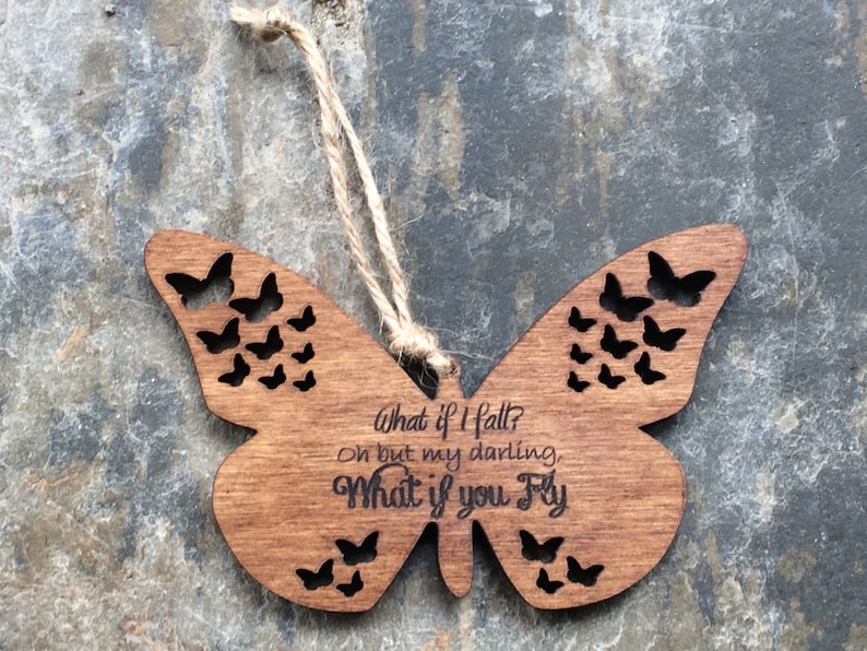May include: Wooden butterfly ornament with a cutout design and the text "What if I fall? Oh but my darling, What if you fly."