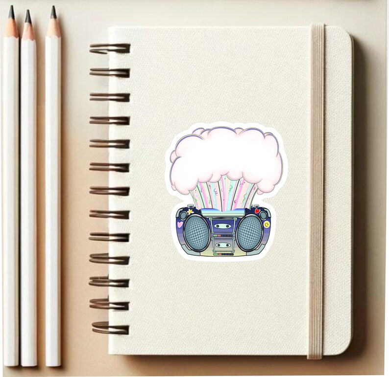 May include: A sticker featuring a retro boombox with a pink and white cloud exploding out of the top. The boombox has a blue and black design with colorful buttons and a cassette tape slot.