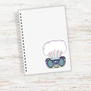 May include: A sticker of a vintage boombox with a cloud of rainbow colored smoke coming out of it.
