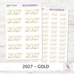 May include: Two sheets of adhesive stickers featuring the year 2027 in a gold metallic font. The larger sheet contains twelve 2027 stickers, while the smaller sheet features twenty-four 2027 stickers. Both sheets include the text BOLDERBON.
