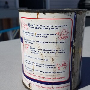 May include: A white metal can with red and blue text and illustrations. The text reads "450&deg; melting point compared with 350&deg; in fibre greases. Water proof - won't break down if water gets into the hub. Will mix with other types of wheel bearing grease. Higher film strength than previously possible in wheel bearing greases. No bleeding or throw-out. Meets specifications approved by leading wheel bearing makers. Good consistency very well in temperature changes. An ideal lubricant for water pumps & universal joints. DON EQUIPMENT SERVICE"