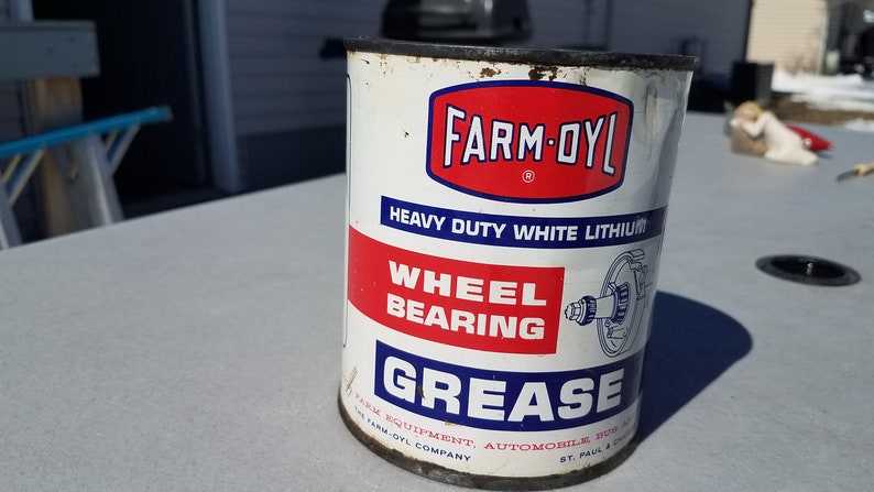 May include: A white can of Farm-Oyl Heavy Duty White Lithium Wheel Bearing Grease. The can has red and blue lettering and a picture of a wheel bearing.