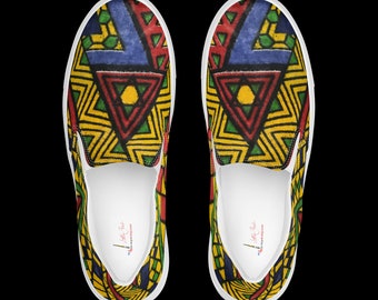 May include: A pair of slip-on shoes with a vibrant geometric pattern in red, yellow, green, and blue. The shoes have a white sole and a colorful design on the top. The pattern features triangles and zigzags.