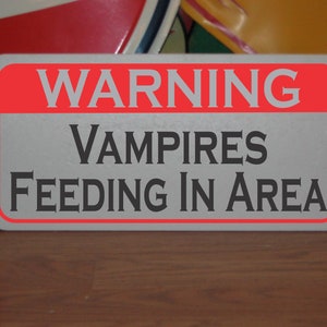 Vampires feeding in Area Metal Sign warning