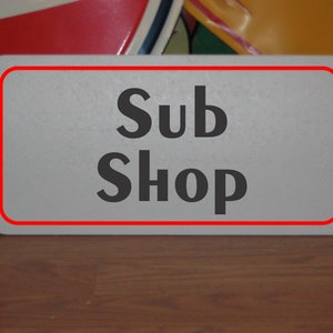 Metalowy znak Sub Shop