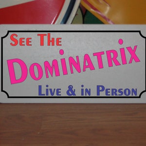 See The DOMINATRIX Live and in Person Metal Sign