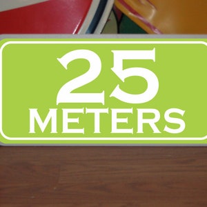 May include: A green sign with white text that reads "25 meters".
