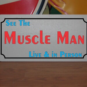 See The Muscle Man Metal Sign carnival circus fair