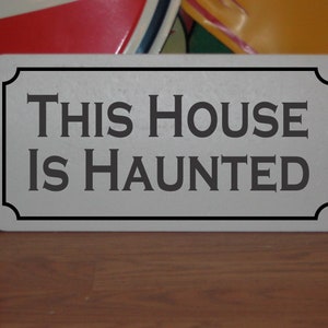 This House is Haunted Metal Sign