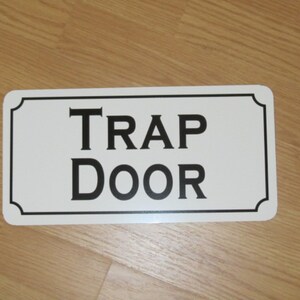 TRAP DOOR Metal sign