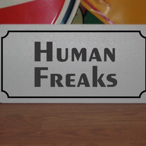 Human Freaks Metal Sign