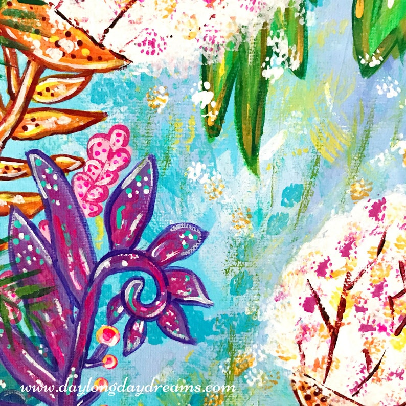 May include: A colorful abstract painting with a blue background and various floral elements. The painting features pink, purple, green, and orange flowers with white accents. The painting has a textured surface and a whimsical style.