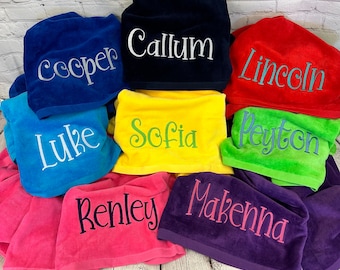 May include: A collection of nine colorful towels with embroidered names, including "Callum", "Cooper", "Lincoln", "Luke", "Sofia", "Peyton", "Renley", "Makenna", and "Sophia".