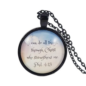 May include: Black chain necklace with a round glass pendant featuring a cloudy sky background and the text "I can do all things, through Christ who strengthens me. Phil. 4:13"