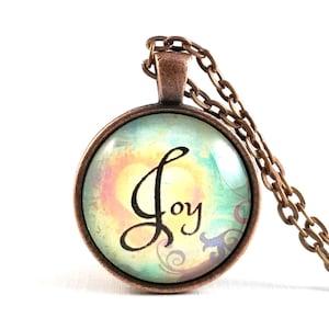 May include: A copper chain necklace with a round glass pendant featuring a watercolor background and the word "Joy" in black calligraphy.