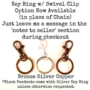 May include: Three key rings with swivel clips in bronze, silver, and copper. The text reads: "Key Ring w/ Swivel Clip Option Now Available (in place of Chain) Just leave me a message in the 'notes to seller' section during checkout Bronze Silver Copper *Black Pendants come with Silver Key Ring unless otherwise requested."