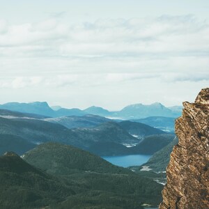 a man standing on top of a mountain with a backpack