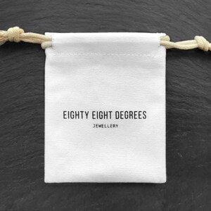 a white bag with a rope hanging from it