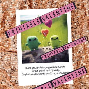 May include: Printable Valentine's Day card featuring two green fuzzy creatures holding balloons in the shape of hearts. The card reads "Thank you for being my partner in crime in this grand heist of sanity. Together we will rob the world of its seriousness."