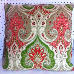 May include: A decorative cushion with a paisley pattern in shades of green, red, and cream.