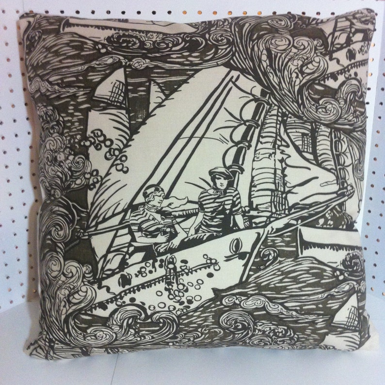 May include: A decorative pillow with a black and white illustration of two people on a sailboat in a stormy sea. The background is filled with swirling waves and clouds.