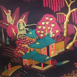 May include: A black fabric with a repeating pattern of pink and white stylized trees, houses, and flowers. The design is reminiscent of traditional Chinese artwork.