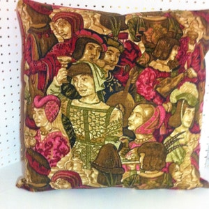 May include: A decorative pillow with a medieval tapestry design featuring people in colorful clothing and a musical instrument. The background is a rich brown with gold accents.