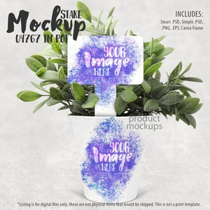 May include: White ceramic pot with a watercolor design featuring purple and blue hues. The pot is filled with green foliage and a white stake with the text "YOUR Image HERE" in purple lettering. The pot is on a white background.