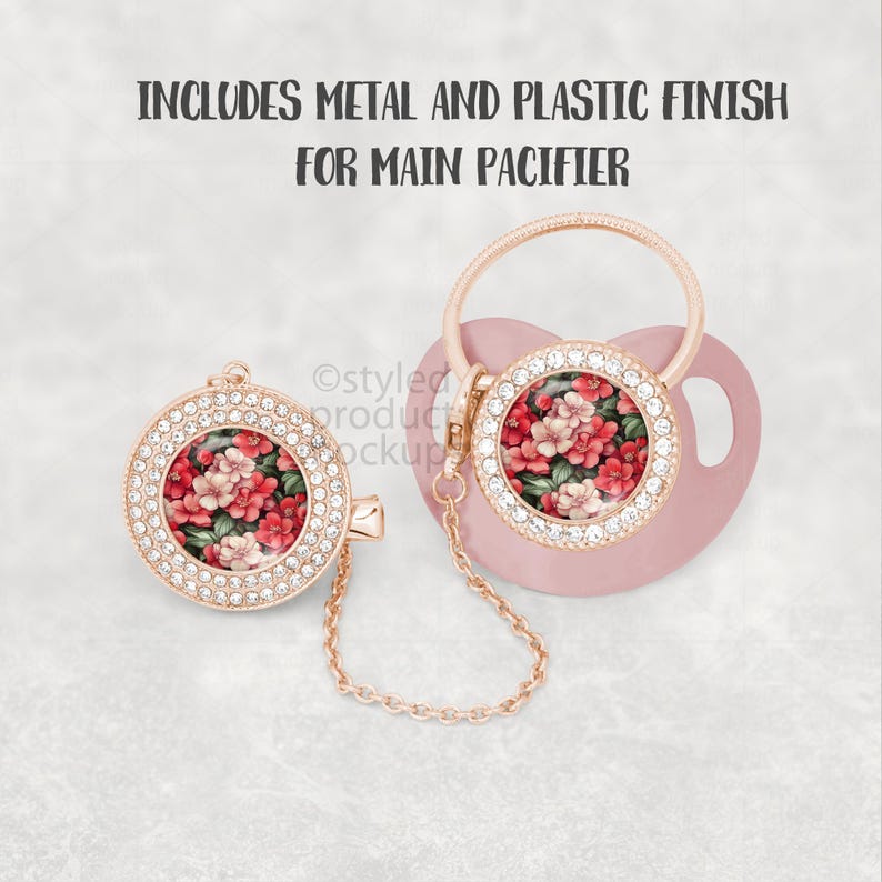 May include: A pink baby pacifier with a floral design and a matching clip. The pacifier and clip have a rose gold finish and are adorned with clear crystals. The pacifier features a floral design with red and pink flowers.