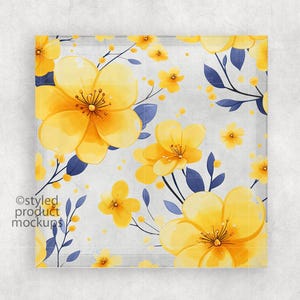 May include: A square glass coaster with a floral pattern. The coaster features yellow flowers with blue leaves on a white background.