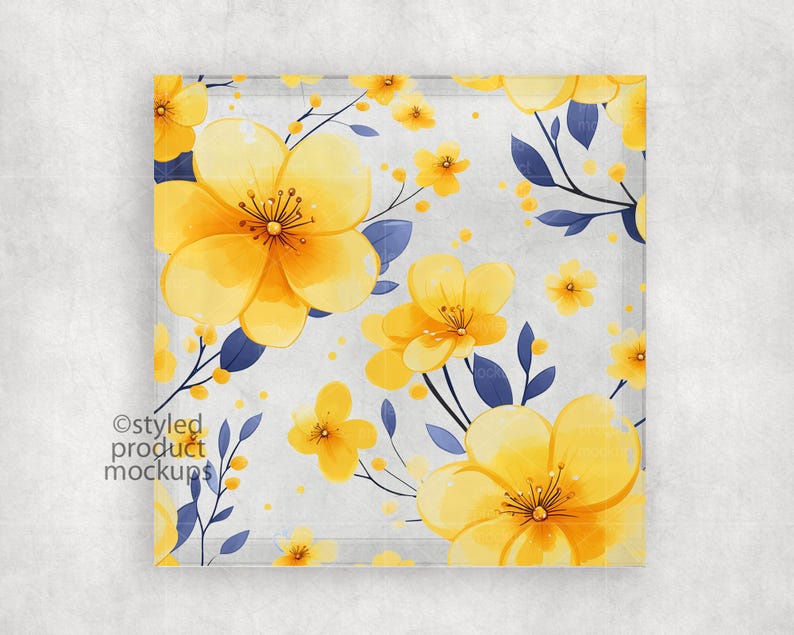 May include: A square glass coaster with a floral pattern. The coaster features yellow flowers with blue leaves on a white background.