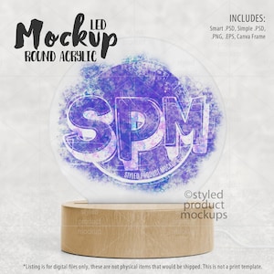 May include: A round acrylic LED sign mockup with a wooden base. The sign is illuminated with a purple and blue watercolour effect and the text "SPM" is visible on the sign. The text "Styled Product Mockups" is also visible on the sign.