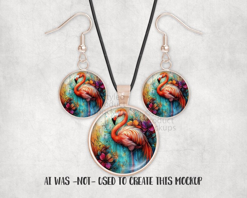 May include: A jewellery set with a flamingo design. The set includes a pendant necklace and a pair of earrings. Each piece has a round, silver-toned frame with a colourful flamingo illustration. The flamingo is in pink and orange, set against a teal and floral background.