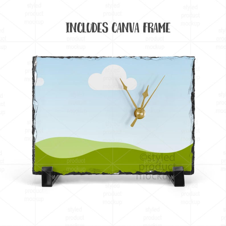 Puede incluir: Un reloj rectangular de pizarra con un dise&ntilde;o de paisaje que presenta un cielo azul, nubes blancas y colinas verdes. El reloj tiene manecillas doradas y un soporte negro. El texto "INCLUDES CANVA FRAME" est&aacute; en la parte superior.