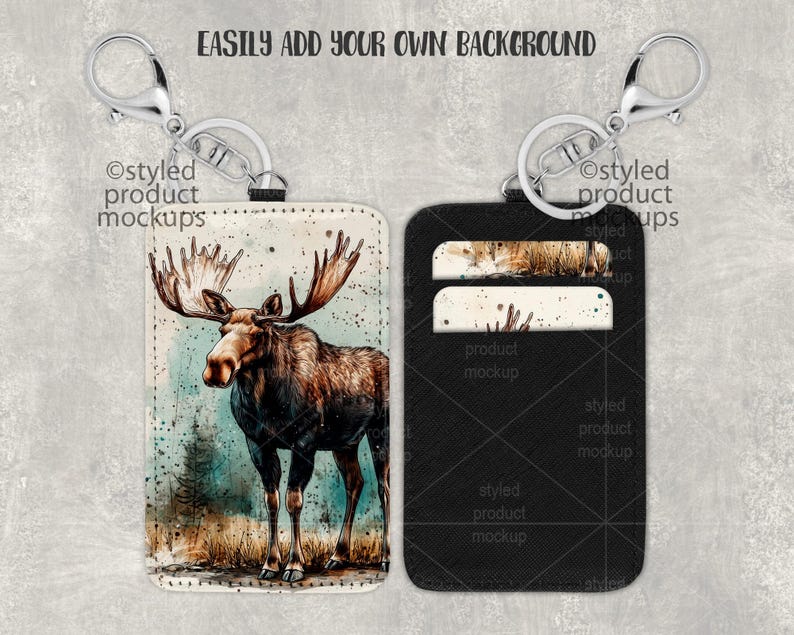 May include: A black leather keychain with a moose illustration on one side and two card slots on the other side. The keychain is attached to a silver split ring.
