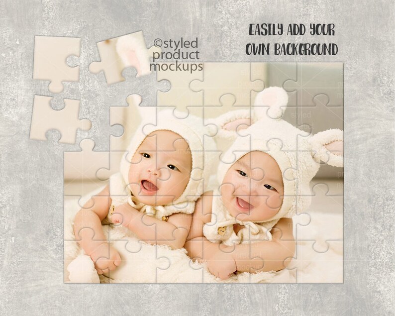May include: Two babies wearing white bunny costumes are lying on a white blanket. The babies are smiling and looking at the camera. The image is a jigsaw puzzle with some pieces missing.