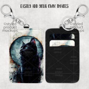 May include: Two black leather keychains with a silver metal ring. One keychain has a black cat with blue eyes on a white background. The other keychain has a black background with a white card holder.