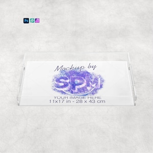 May include: A clear acrylic tray with a rectangular shape and raised edges. The tray features the text "Mockup by SPM" and "YOUR IMAGE HERE 11x17 in - 28 x 43 cm" in the center. The tray is designed for display purposes.