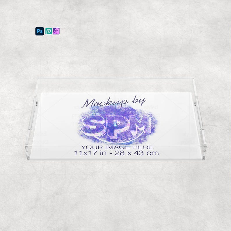 May include: A clear acrylic tray with a rectangular shape and raised edges. The tray features the text "Mockup by SPM" and "YOUR IMAGE HERE 11x17 in - 28 x 43 cm" in the center. The tray is designed for display purposes.
