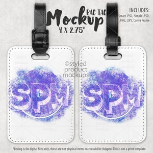 May include: Two white luggage tags with black straps. Each tag has a watercolor-style background with a purple and blue design. The text "SPM" is in the center of each tag.