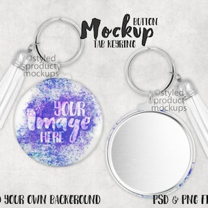 May include: A mockup of a button keychain with a white tassel. The button is round and has a white background with a purple and blue watercolor design. The text "YOUR IMAGE HERE" is written on the button. The keychain is silver and has a ring for attaching keys.