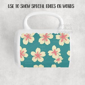 May include: White ceramic mug with a teal floral pattern. The design features cream-colored flowers with pink centers. The mug has a white handle and the text "USE TO SHOW SPECIAL EDGES OR WORDS" at the top.