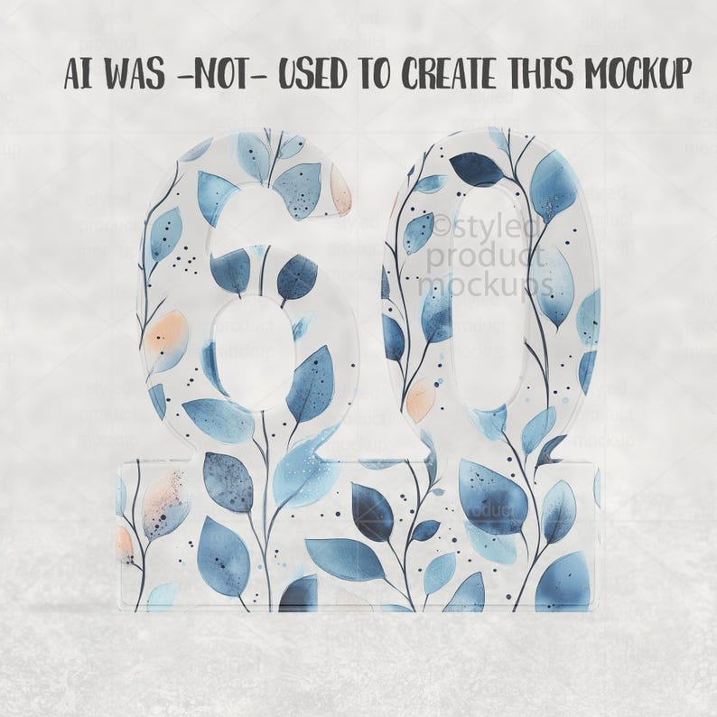 Op de afbeelding: Een decoratief nummer 60, met een bloemmotief van blauwe en perzikbladeren op een witte achtergrond. De transparante cijfers staan op een bijpassende basis. De tekst "AI WAS -NOT- USED TO CREATE THIS MOCKUP" staat bovenaan.